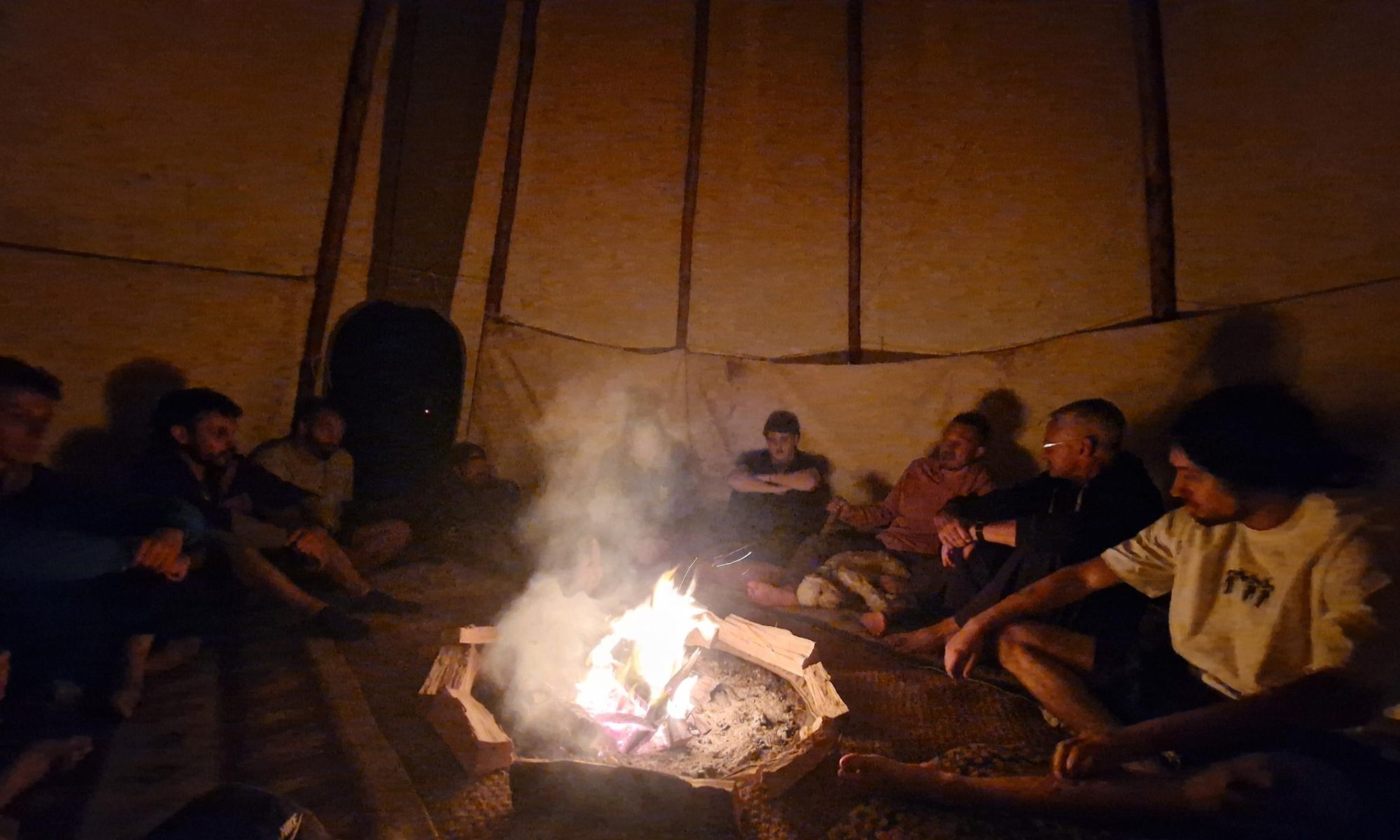 The circle around the fire inside the tipi at night