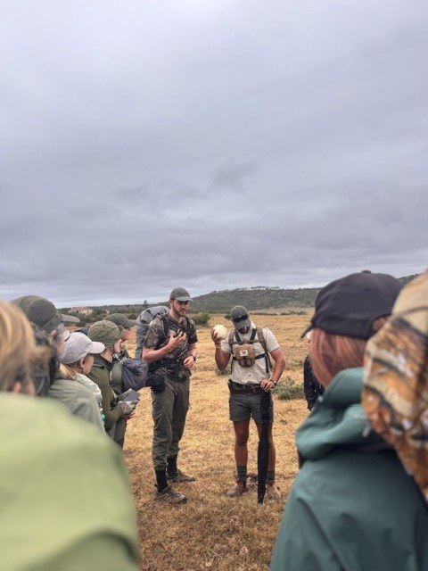 Guests in the field with guides and rangers